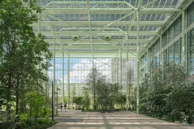 a large glass building with trees inside of it at The Standard, Brussels in Brussels