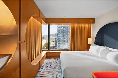 a hotel room with a bed and a window at The Standard, Brussels in Brussels