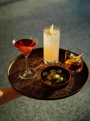 a tray with two cocktails and a bowl of olives at The Standard, Brussels in Brussels