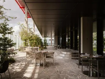a restaurant with tables and chairs in front of a building at The Standard, Brussels in Brussels