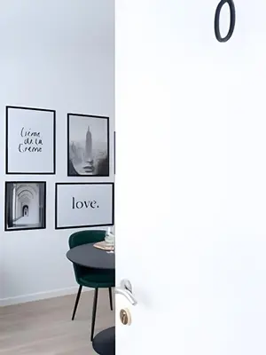 a room with a table and pictures on the wall at Studio calme et fonctionnel – idéal séjour pro in Brussels
