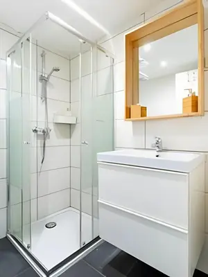 a bathroom with a glass shower and a sink at Studio calme et fonctionnel – idéal séjour pro in Brussels