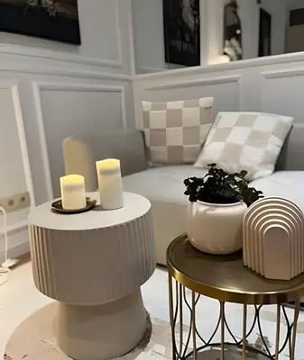 a living room with two tables and a couch at Charming studio, perfect getaway in Brussels