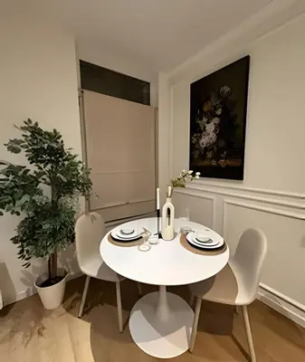 a white dining room with a white table and chairs at Charming studio, perfect getaway in Brussels
