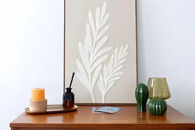 a table with a candle and a picture on a wall at Studio lumineux, idéal pour séjour pro in Brussels