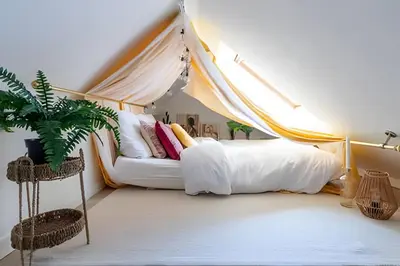 a bedroom with a bed with a canopy at Appartement cosy et central – séjour pro in Brussels