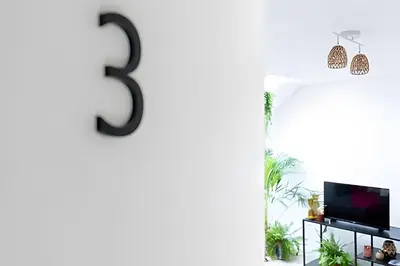 a black number three on a wall in a living room at Appartement cosy et central – séjour pro in Brussels