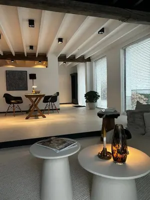 a living room with two tables and a couch at English Bob in Bierbeek