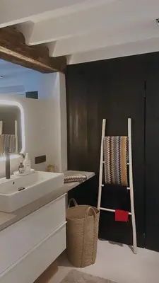 a bathroom with a sink and a mirror and a chair at English Bob in Bierbeek