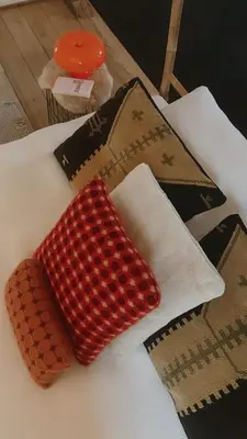 two red pillows sitting on top of a bed at English Bob in Bierbeek