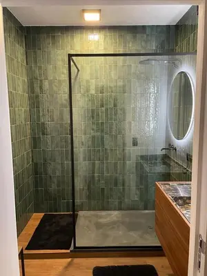 a shower with a glass door in a bathroom at The Green Gatsby II in Antwerp