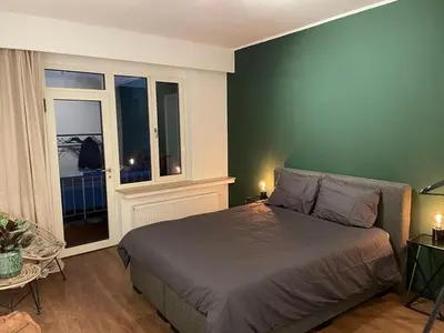 a bedroom with a bed and a window at The Green Gatsby II in Antwerp