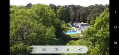 an image of a house with a river and a sign at Stavros in Schoten