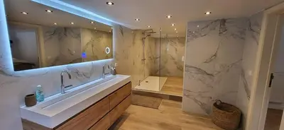 a bathroom with a sink and a large mirror at Stavros in Schoten