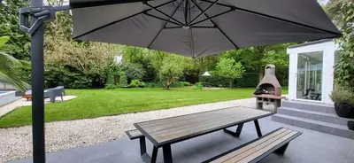 a picnic table and an umbrella on a patio at Stavros in Schoten