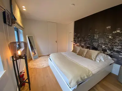 a bedroom with a large bed with a city wall at Oase d'Itegem - Wellness & Luxe in Heist-op-den-Berg