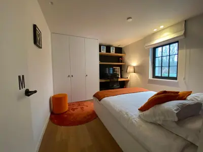 a white bedroom with a bed and a window at Oase d'Itegem - Wellness & Luxe in Heist-op-den-Berg