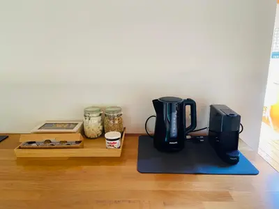 a coffee maker sitting on a table next to a counter at Cosy house 6 people in Kontich