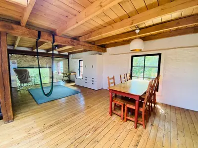 a dining room with a wooden table and chairs at Cosy house 6 people in Kontich