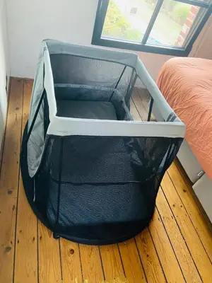 a suitcase sitting on the floor next to a bed at Cosy house 6 people in Kontich