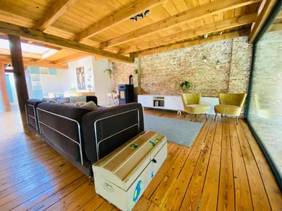 a living room with a couch and a table at Cosy house 6 people in Kontich