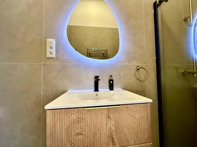 a bathroom with a sink and a mirror at Luxury Suites Royal by Rikas Hotels in Antwerp