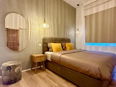 a bedroom with a large bed and a mirror at Luxury Suites Royal by Rikas Hotels in Antwerp