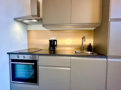 a small kitchen with a sink and a stove at Luxury Suites Royal by Rikas Hotels in Antwerp