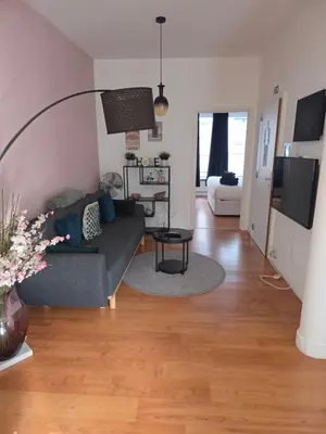 a living room with a couch and a table at Lovely & Modern apartment in the heart of Antwerp in Antwerp