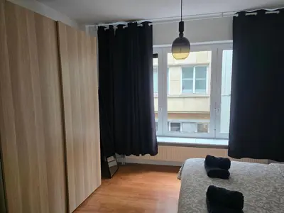 a bedroom with a bed and a large window at Lovely & Modern apartment in the heart of Antwerp in Antwerp