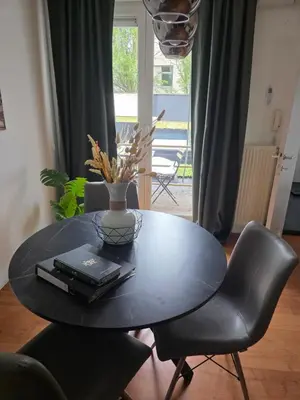 a black table with a vase on top of it at Lovely & Modern apartment in the heart of Antwerp in Antwerp