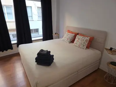 a bedroom with a bed with two pillows on it at Lovely & Modern apartment in the heart of Antwerp in Antwerp