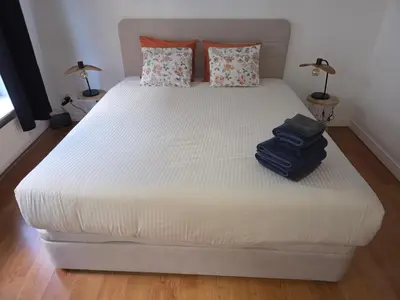 a bed with two suitcases on it in a bedroom at Lovely & Modern apartment in the heart of Antwerp in Antwerp