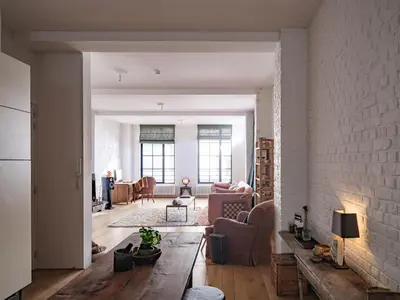 a living room with a couch and a brick wall at Brooklyn Five in Ghent