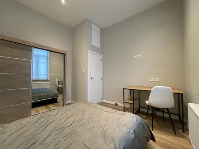 a bedroom with a bed and a desk with a chair at Midi Station in Brussels