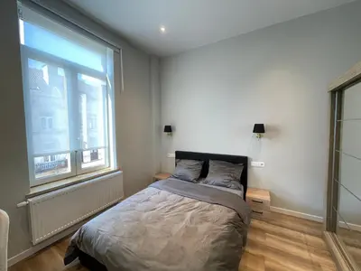 a bedroom with a bed and a large window at Midi Station in Brussels