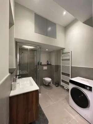 a bathroom with a sink and a washing machine at Midi Station in Brussels
