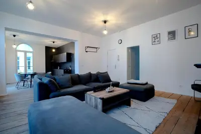 a living room with a blue couch and a table at 2BR Apartment AA Location Antwerp in Antwerp