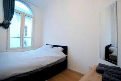 a bedroom with a bed and a window at 2BR Apartment AA Location Antwerp in Antwerp