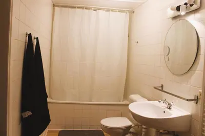 a bathroom with a sink and a toilet and a mirror at Madame Chapeau II in Brussels