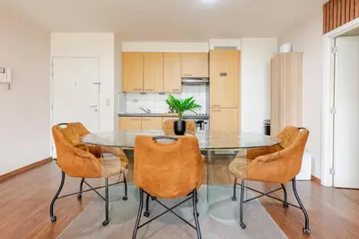 a kitchen and dining room with a glass table and chairs at The Stalle in Brussels