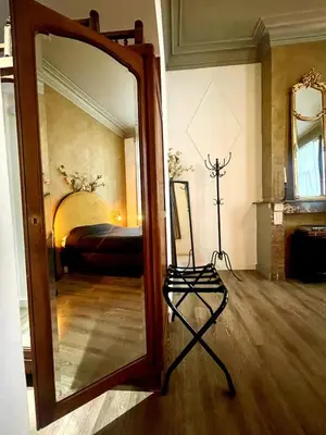 a large mirror in a room with a bedroom at The Cozy Guestroom near Park Zuid and Musea in Antwerp