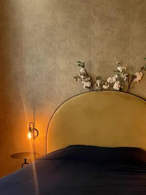 a bed with a head board with flowers on it at The Cozy Guestroom near Park Zuid and Musea in Antwerp
