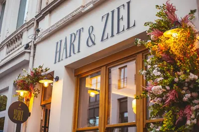 a store front of a shop with flowers on the facade at The Cozy Guestroom near Park Zuid and Musea in Antwerp