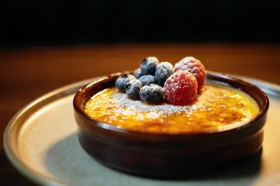 a bowl of food with berries on a plate at The Cozy Guestroom near Park Zuid and Musea in Antwerp