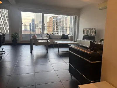 a living room with a view of a city at Charming central apartments with balcony views in Brussels