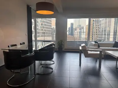 a dining room with a table and chairs in a building at Charming central apartments with balcony views in Brussels