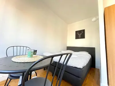 a small room with a table and a bed at Beautiful & Charming studio EU DISTRICT in Brussels