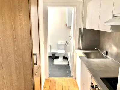 a small bathroom with a toilet and a sink at Beautiful & Charming studio EU DISTRICT in Brussels
