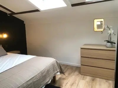 a bedroom with a bed and a dresser with flowers on it at Absolute Charm 3 Bedroom 3 Bathroom with AC EU District in Brussels